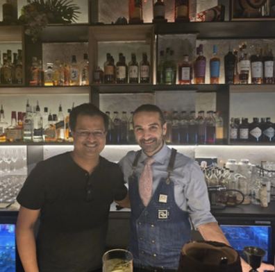 Guild representative with a bartender behind a back bar