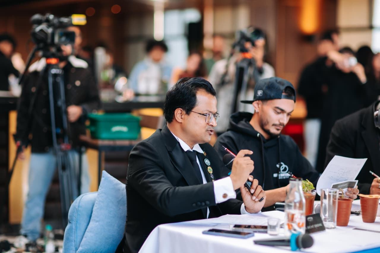 Judging panel assessing a competitor's cocktail at a guild competition